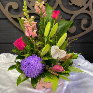 Seasonal mixed flower arrangement in a container